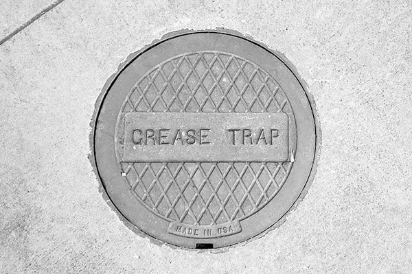 grease trap pumping removes the accumulation of grease and solids that can cause plumbing blockages and backups